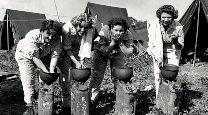 Army nurses, left to right, Lieutenant Margaret J. Whitton, Lieutenant Ruth Anderson, Lieutenant Marjorie Dulain, and Lieutenant EleanorKennedy, wash out of steel helmets, on Okinawa, May 7, 1945 (National Archives and Records Administration/U.S. Army Signal Corps)
